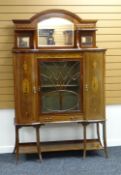 A CABINET SIDEBOARD composed of centre glazed door flanked by a pair of bowed cupboards and with