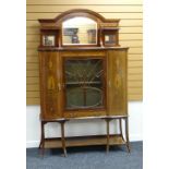 A CABINET SIDEBOARD composed of centre glazed door flanked by a pair of bowed cupboards and with