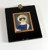 A 1787 DATED MINIATURE PORTRAIT probably on ivory and of a lady in a blue dress with jewellery and