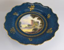 A ROYAL WORCESTER CAKE STAND having a circular painted landscape scene of 'Cardiff Castle' signed