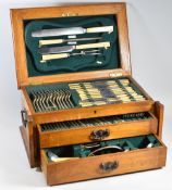 AN OAK CANTEEN OF EPNS CUTLERY near complete with four piece carving set and three tiers of Sterling