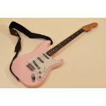 A FENDER STRATOCASTER contour body, pink with white scratchplate together with carry case, serial