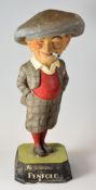 A PLASTER 'PENFOLD' ADVERTISING GOLFER the smiling plus-four wearing figure with hands in his