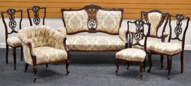 A SEVEN-PIECE ANTIQUE SALON SUITE in matching floral upholstery and being a combination of two-