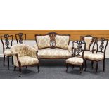 A SEVEN-PIECE ANTIQUE SALON SUITE in matching floral upholstery and being a combination of two-
