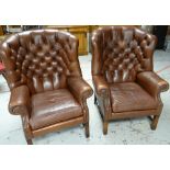 A PAIR OF BUTTONED BROWN LEATHER ARMCHAIRS