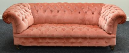 A CHESTERFIELD-STYLE SETTEE in buttoned pink dralon fabric