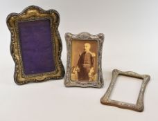 A PAIR OF SILVER EASEL FRAMES & ANOTHER LARGER (variable condition)