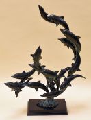 A SAN PACIFIC INTERNATIONAL BRONZE SCULPTURE OF A DOLPHIN POD on an ebonised platform base and