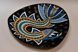 A LARGE CONTEMPORARY POTTERY CHARGER with stylized bird in a black background, 49cms high