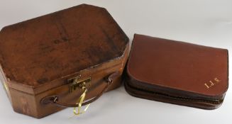 TWO LEATHER CASED VANITY SETS one being of lockable box form with monogram to lid and complete