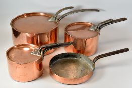 A GRADUATED SET OF THREE ANTIQUE COPPER LIDDED SAUCE PANS, each pan and lid with iron handles, the