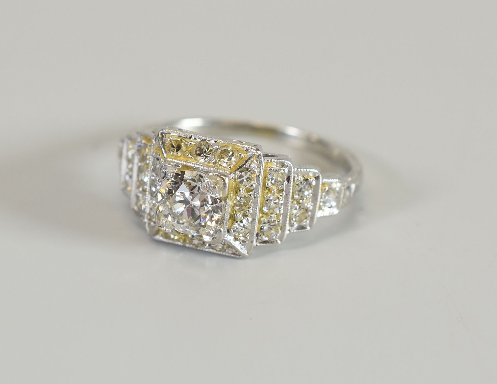 A PLATINUM ART DECO DIAMOND RING with stepped mount, the centre raised diamond 0.55cts approx (