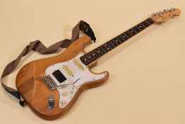 A SQUIER STRATOCASTER BY FENDER wood with white scratchplate and carry case, serial number