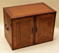 A GERMAN MARQUETRY TABLE CABINET constructed from various specimens of wood, the two doors opening