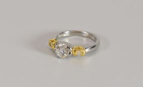 A PLATINUM & YELLOW GOLD DIAMOND SOLITAIRE RING, the diamond raised in a five claw setting, visual