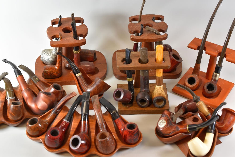 A COLLECTION OF 28 SMOKING PIPES of various forms together with nine stands