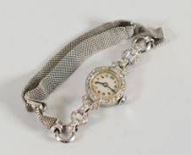 A LADIES VINTAGE COCKTAIL WATCH encrusted with diamonds, the white gold bracelet marked 9ct, the