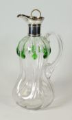 A GLASS DECANTER WITH SILVER COLLAR & SPOUT having a handle and swirling waisted body with green