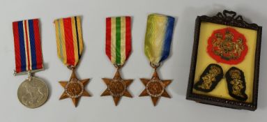 A PARCEL OF WWII MEDALS, unnamed, together with three embroidered military crests in a small easel