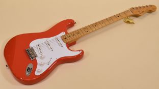 A FENDER STRATOCASTER in red with white scratchplate, signed Hank Marvin together with another