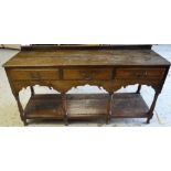 A NINETEENTH CENTURY WELSH OAK DRESSER BASE having an open platform base below three drawers and a