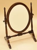 AN EDWARDIAN INLAID MAHOGANY OVAL TOILET MIRROR on a delicate stand, 47cms high