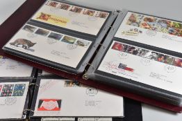 TWO PURPLE ALBUMS OF ROYAL MAIL FIRST DAY COVERS and a black similar