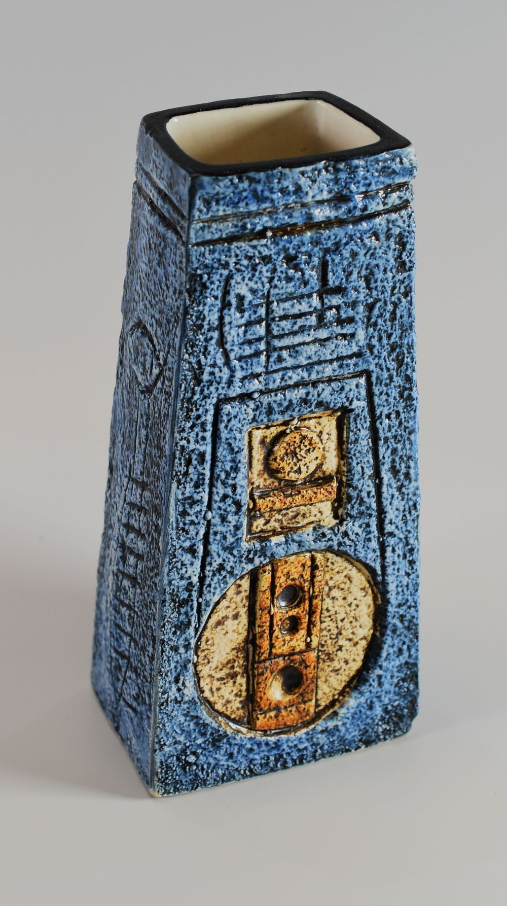 A TROIKA SLAB SIDED TAPERED COFFIN-VASE typically decorated with mottled blue and brown glaze,