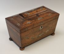 A MOTHER-OF-PEARL INLAID ROSEWOOD TEA-CADDY of sarcophagus form on bun feet, the interior divided