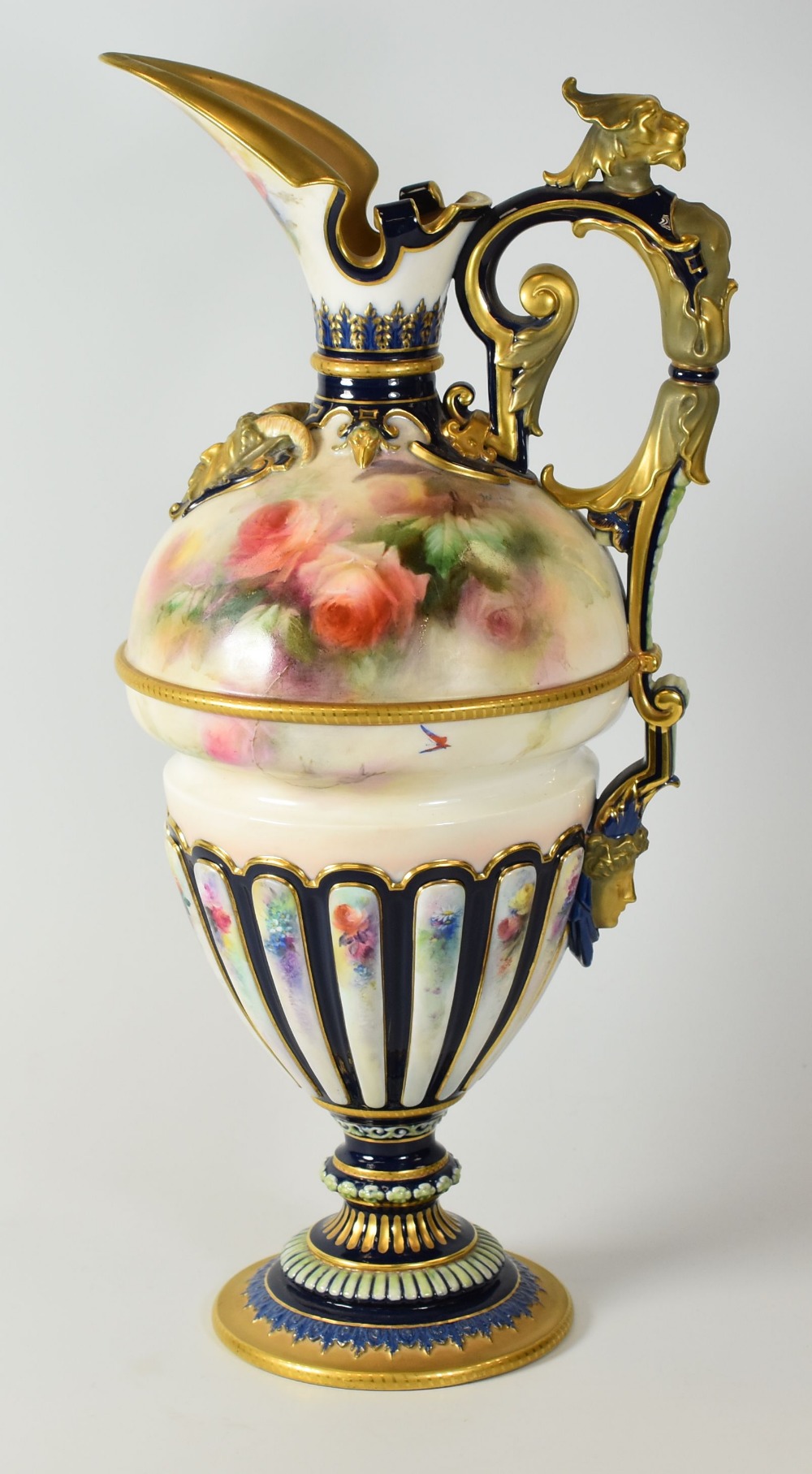 A HADLEY WORCESTER CLARET JUG of elaborate Classical form with spear spout and fluted decoration
