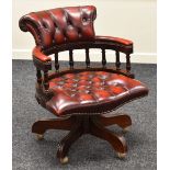 A REPRODUCTION CAPTAIN-STYLE OFFICE CHAIR with buttoned red leather upholstery