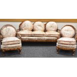 AN EDWARDIAN POLISHED THREE-PIECE BERGERE SUITE comprising three-seater lobed settee and a pair of