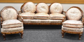 AN EDWARDIAN POLISHED THREE-PIECE BERGERE SUITE comprising three-seater lobed settee and a pair of