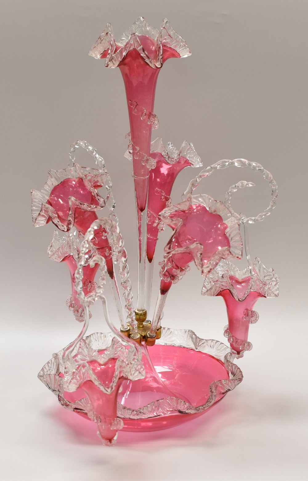 A VICTORIAN CRANBERRY GLASS FANCY EPERGNE having six alternating branches, 56cms high together