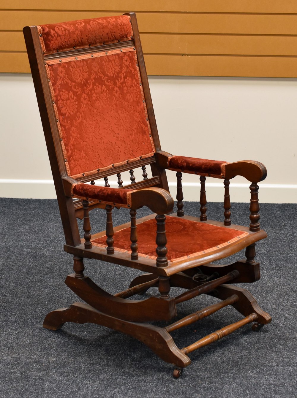 AN AMERICAN-STYLE ROCKING CHAIR with pink floral upholstery