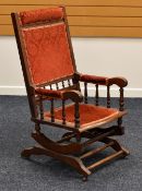 AN AMERICAN-STYLE ROCKING CHAIR with pink floral upholstery