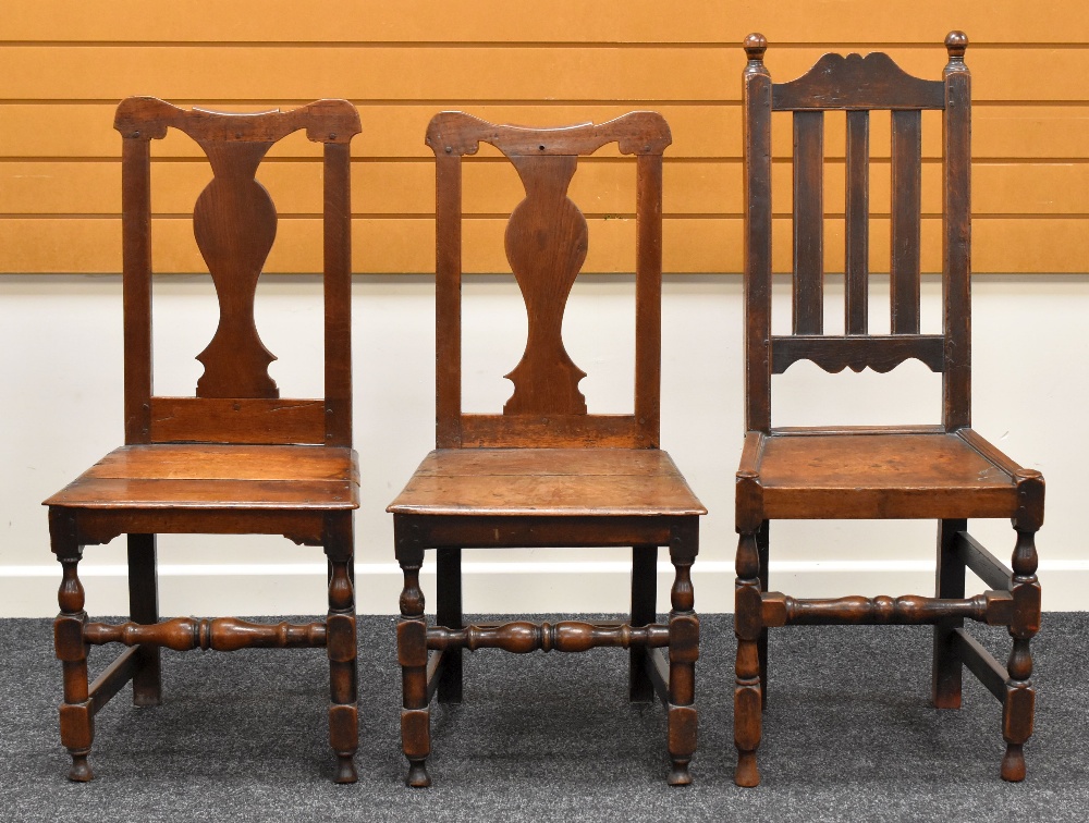 A PAIR OF FARMHOUSE CHAIRS having shaped splat backs and with turned and block stretchers;
