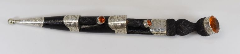 A SCOTTISH HIGHLAND ORNAMENTAL DIRK (blade-less) in darkwood with 'citrines' to the pommel,