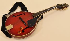 A VINTAGE ELECTRIC MANDOLIN in red together with carry case and leads, 68cms long