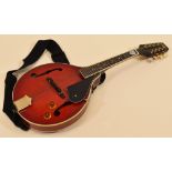 A VINTAGE ELECTRIC MANDOLIN in red together with carry case and leads, 68cms long