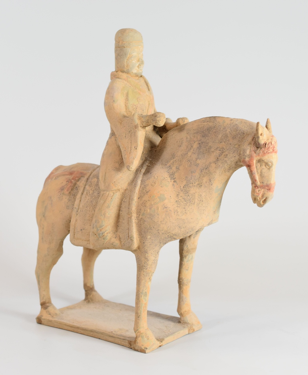 A CHINESE ARCHAIC TERRACOTTA TOMB-HORSEMAN standing on a rectangular base, 27cms high - Image 2 of 2