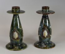 A PAIR OF DOULTON LAMBETH CANDELHOLDERS of baluster form in mottled green glaze with Art Nouveau