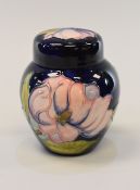 A MOORCROFT GINGER JAR & COVER typically tube-line decorated with coral coloured flowers to a deep