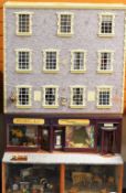 AN IMPRESSIVE FLOOR STANDING DOLLS HOUSE in a form of a high street town house with 'ground