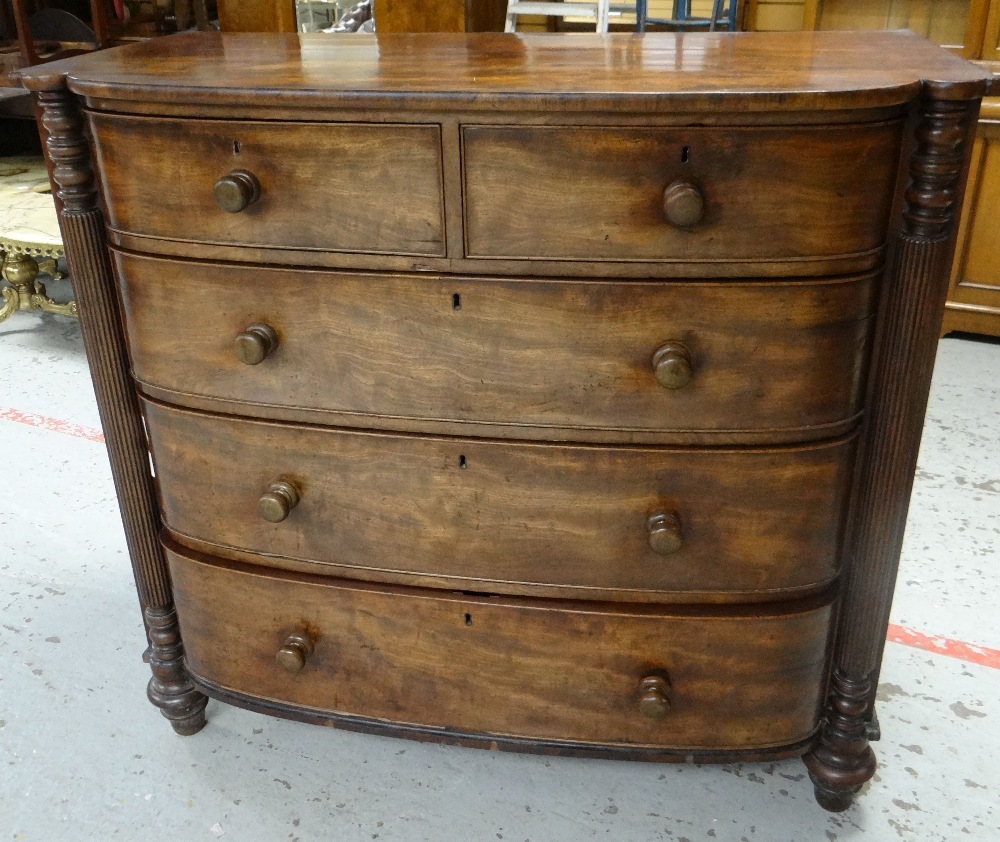 A VICTORIAN MAHOGANY CHEST of three long and two short drawers with fluted half column flanks on bun