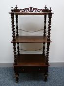 A VICTORIAN MAHOGANY THREE TIER WHATNOT with single drawer base, the pierced gallery top with finial