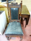 A CIRCA 1900 CARVED WALNUT SIDE CHAIR, the fancy top rail over a padded panel back, flanking