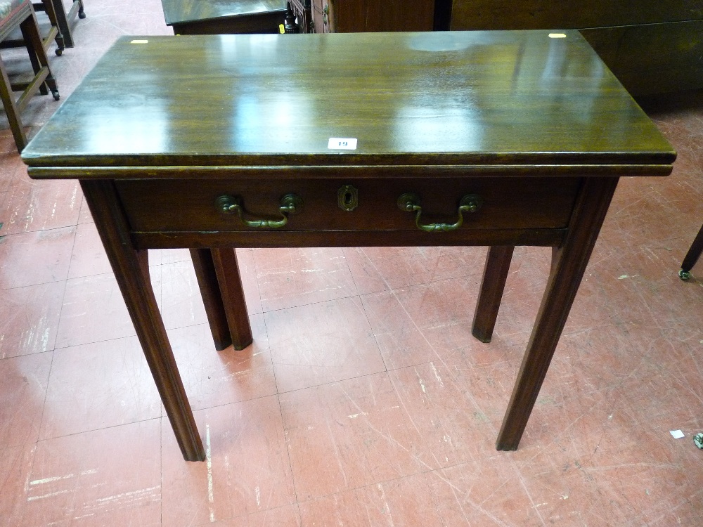 A LATE 19th CENTURY NEAT OBLONG MAHOGANY FOLDOVER TEA TABLE having a long narrow drawer with brass