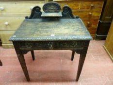 A JACOBEAN STYLE CARVED OAK SIDE TABLE with shaped railback and shelf on a rectangular top with